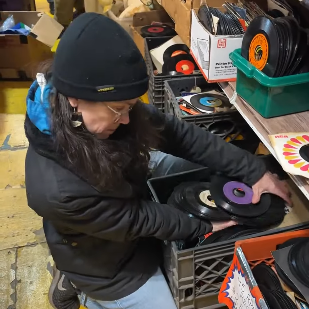 Leah digging through records