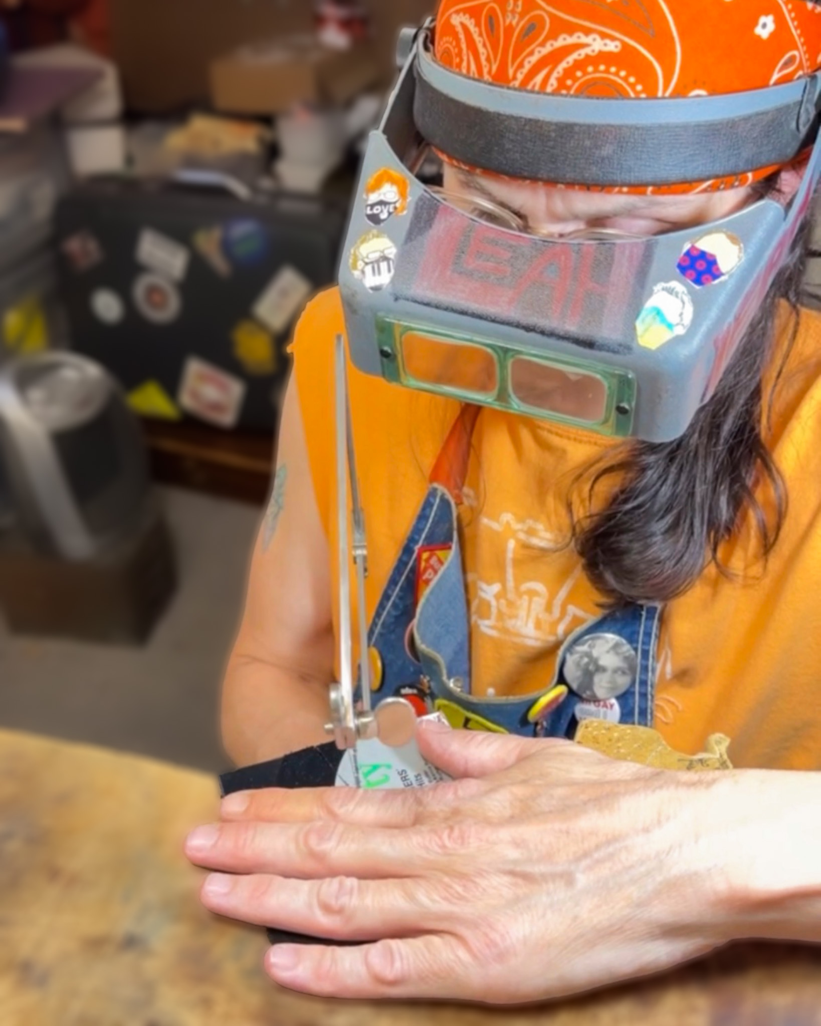 Leah hand cutting vinyl at her jeweler's bench