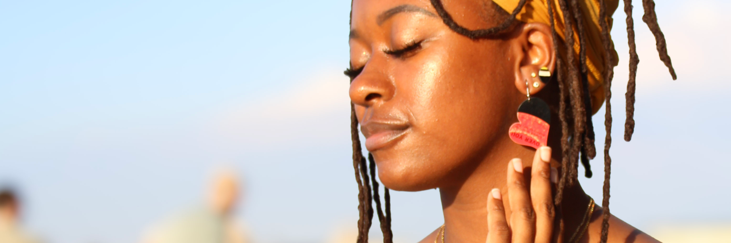 Model wearing handmade reVinyled heart earrings