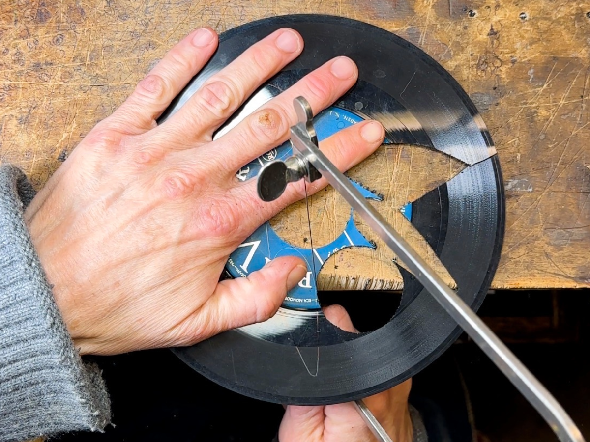 Cutting a vinyl record by hand with a jeweler's saw
