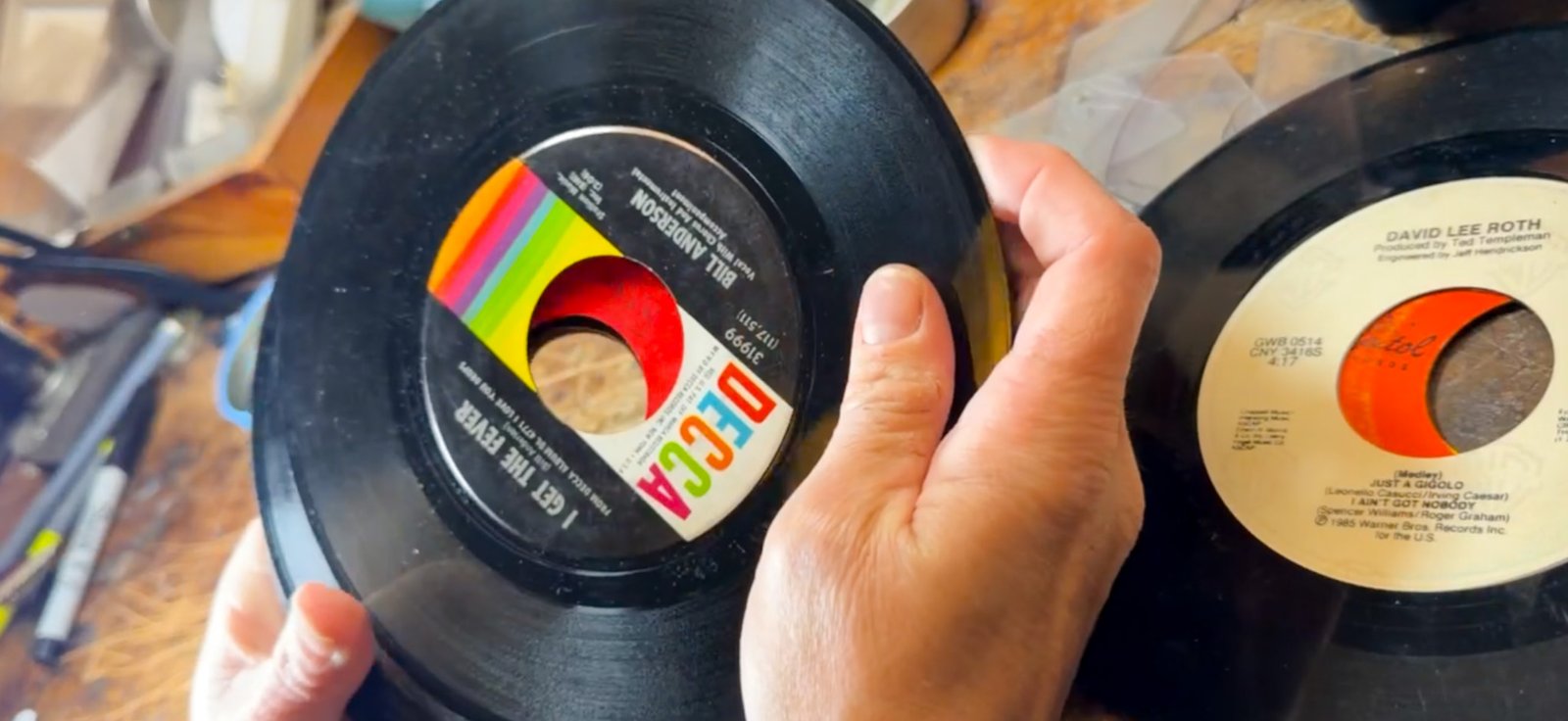 Records and hands at the reVinyled workbench